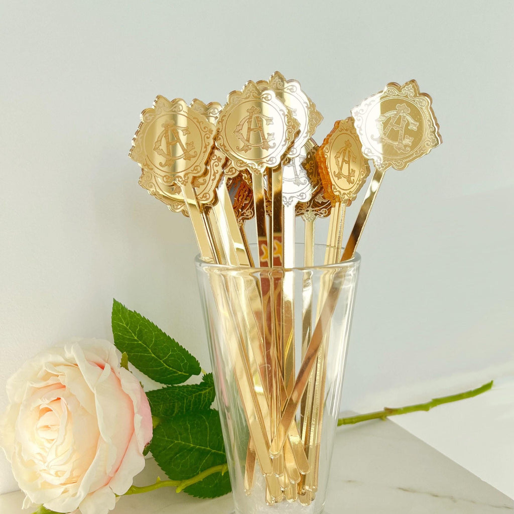 A set of gold mirrored cocktail stirrers with a decorative, sophisticated mirrored design. Stirrers are in transparent glass.