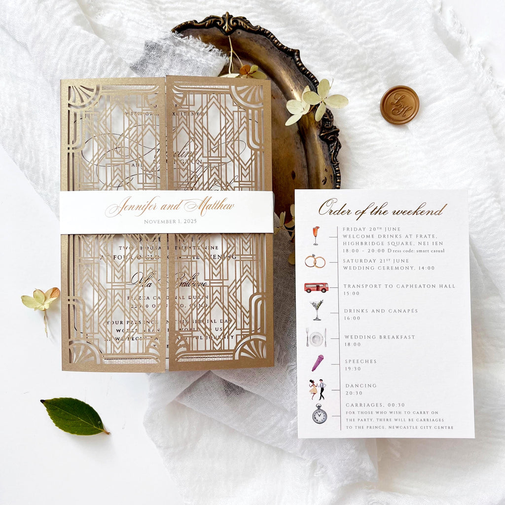 One old gold laser cut invitations with an art deco design. The invitations are gatefold and have a geometric pattern and white wedding invitation